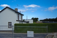 This was the site of the level crossing adjacent to the estuary east of Dungarvan town. This view is looking along what was the railway line towards Waterford. The building seen here is the former crossing keepers house.