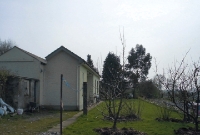 A view looking south towards Tullow at Dunlavin Station. Part of the edging of the former down platform survives on the left. As can be seen, the station building has been extended onto the platform site.