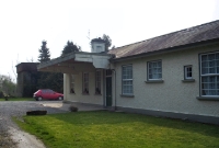 This is the exterior of Dunlavin Station from the forecourt, showing its characteristic canopy over the front entrance.