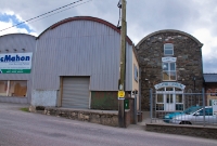 Adjacent to the level crossing at Dunmanway Station was Atkins Mill, the stone building of which is now occupied by a furniture store seen here. The mill had its own siding which was sited to the left on the Bantry side of the former level crossing. The siding remained in situ until complete closure in 1961.