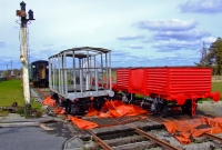 An ex Great Southern &#38; Western 1910 built brakevan and a CIE open wagon are seen preserved at Dunsandle Station. On the left is an original MGWR semaphore signal post.