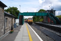201 Class locomotive No.205 enters Westport Station on an afternoon train from Dublin. In this view is the Victorian era Midland Great Western Railway footbridge, and signal cabin visible on the right.