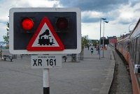 South of Wexford Station the line to Rosslare Harbour passes along the quayside at the town, paralleling the main R730 road. The warning lights complete with steam locomotive sign protect the adjacent R741 road which crosses the railway here.