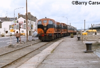 In May 1982, 141 Class loco No.158 leads a train across the R741 road at the south end of Wexford Station en route to Rosslare Habour. Behind No.158 is a 121 Class loco. Until the late 1990s the quay at Wexford was very narrow. ©Barry Carse