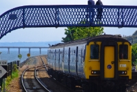 No.8789 approaches the station from the south with a northbound service to Larne Harbour, seen passing beneath the Victorian era footbridge at Whitehead.