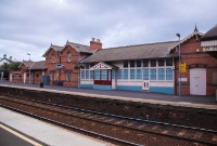 The large red brick built station building, located on the up platform at Whitehead. The majority of the structure is no longer in railway use.