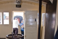 The vintage interior of GNR brakevan No.85 at Whitehead, nicknamed &#39;Ivan&#39;, showing the brake wheel and stove.