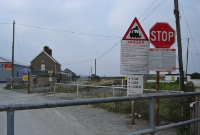 This was the adjacent level crossing on the Rosslare line at Wicklow Jct, looking north towards Dublin. On the left is a building belonging to a former rail served chemical plant.