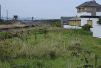 Wicklow Jct, looing north towards Dublin. In the foreground is the trackbed of the former line leading to the Murrough Station, which originally converged here with the main Dublin to Rosslare line, visible on the left. On the right is the large DWWR signal cabin, taken out of use by the Great Southern Railway in 1927.