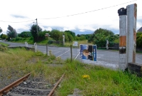 The level crossing gates at Wilkinstown Station have been removed, replaced with a mesh fence, only the wooden gate posts remain.