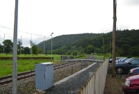A view from the former up platform at Woodenbridge, looking south towards Rosslare. The down platform, once located to the left, has been completely demolished. There is a busy level crossing here leading into Woodenbridge golf course.