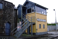 The tall Victorian era Midland Great Western Railway signal cabin at Woodlawn, located adjacent to the level crossing at the west end of the station.